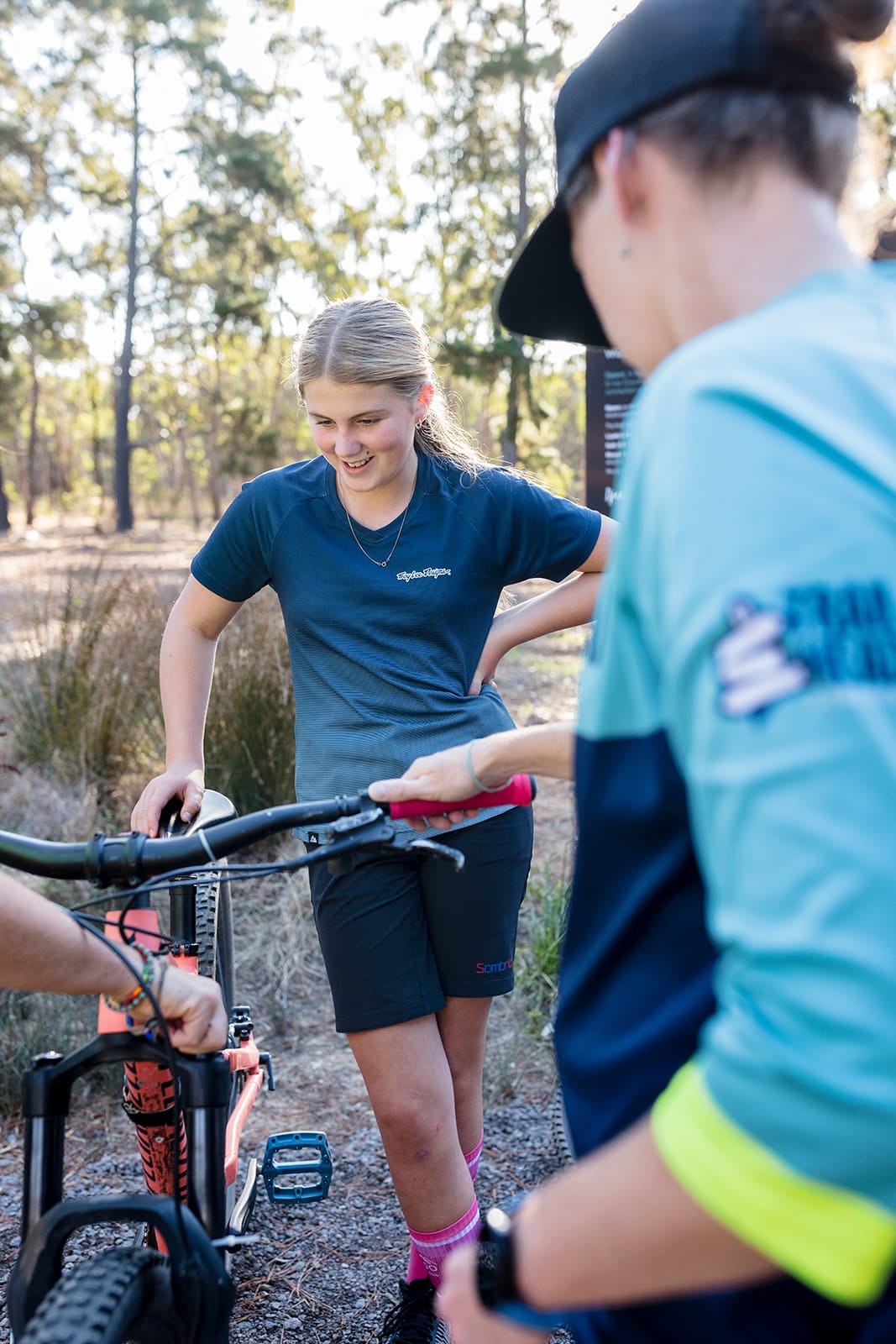Mountain bike coaching group riding on forest trail