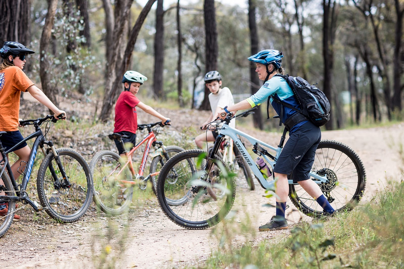 Mountain biking coaching group riding during winter school holiday program